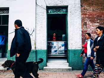 Rear view of people walking in city