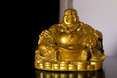 Statue of buddha against black background