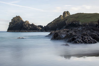 Scenic view of sea and rock formations against sky