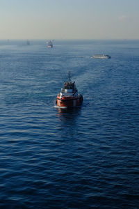 Boat sailing on sea against sky