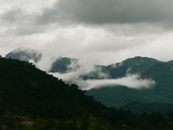 Scenic view of mountains against cloudy sky