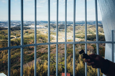 Man seen through window