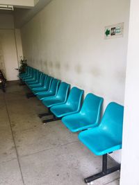 Empty chairs against tiled floor in building
