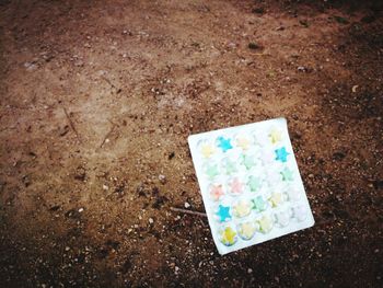 High angle view of multi colored paper on land