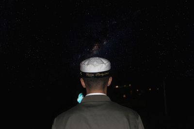 Rear view of man at night