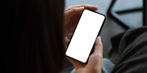 Close-up of hand holding mobile phone