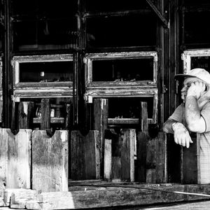 Woman standing by old building