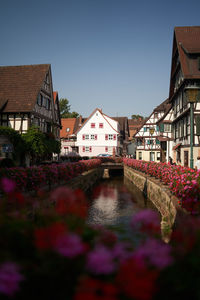 Canal amidst buildings against sky