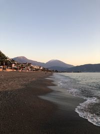 Scenic view of beach against clear sky