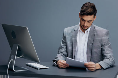 Young man using laptop at office