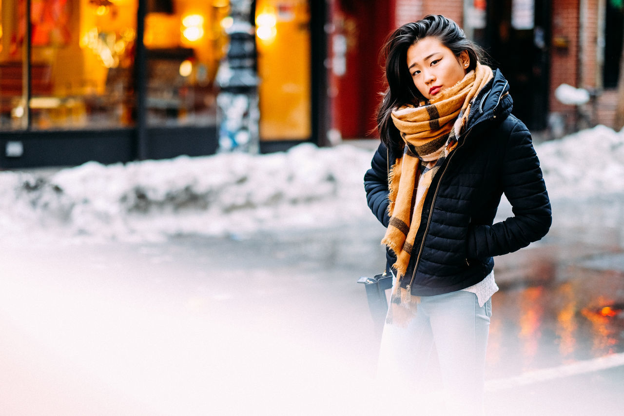 young adult, lifestyles, person, casual clothing, full length, leisure activity, young women, front view, looking at camera, standing, portrait, warm clothing, winter, smiling, three quarter length, long hair, jacket, focus on foreground