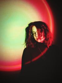 Portrait of woman looking away against sky during sunset