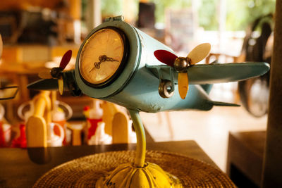 Close-up of clock on table at home