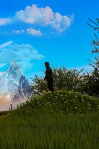 Man standing on field against sky