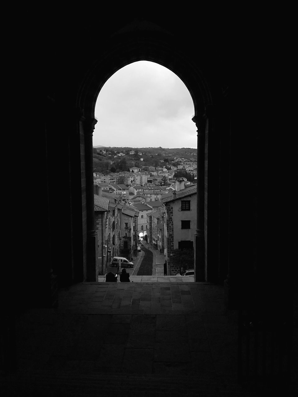 architecture, built structure, building exterior, city, arch, building, nature, sky, day, no people, outdoors, direction, the way forward, street, window, cityscape, transportation, residential district, dark, arched