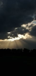 Scenic view of silhouette landscape against dramatic sky
