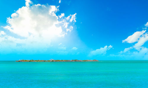 Scenic view of sea against blue sky