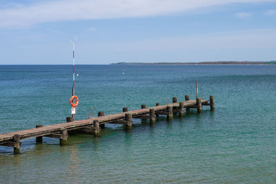 Pier over sea against sky