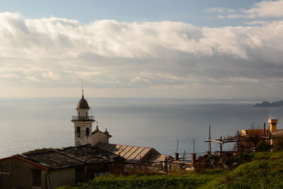 Building by sea against sky