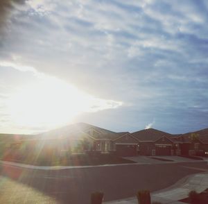 Houses by mountains against sky