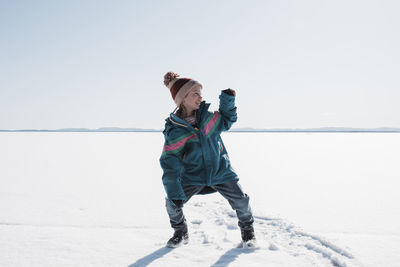 Girl dancing on a frozen lake in sweden