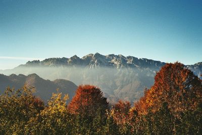 Scenic view of mountains against clear blue sky