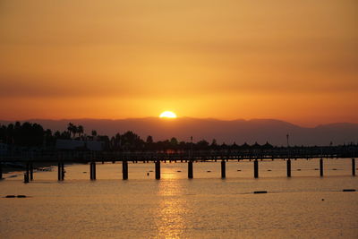 Scenic view of sea against romantic sky at sunset