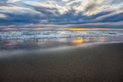 Scenic view of beach against sky during sunset