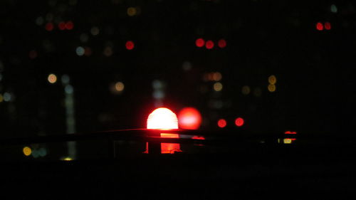 Defocused image of illuminated city at night