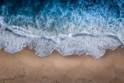 Sea waves splashing on sand