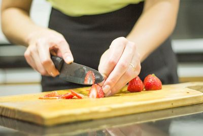 Midsection of woman preparing fruits