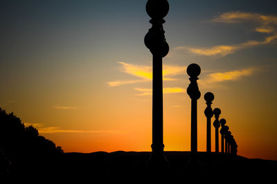 Silhouette of a street lamp post during a beautiful sunset.