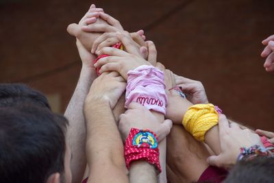 Low section of people on hands