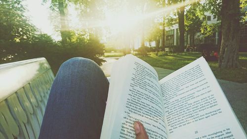 Low section of man reading book