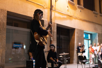 Women standing on stage in city