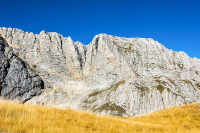 Scenic view of mountains against clear blue sky