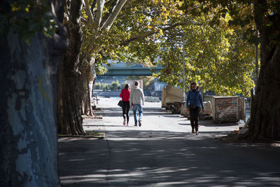 People walking on sidewalk in city