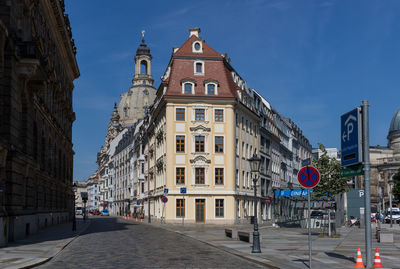 Road amidst buildings against sky in city