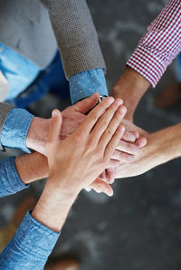 Midsection of couple holding hands