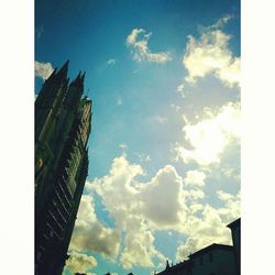 Low angle view of buildings against cloudy sky