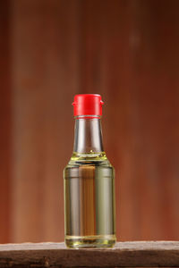 Close-up of liquid in bottle on table