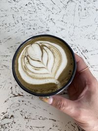 Close-up of hand holding coffee cup