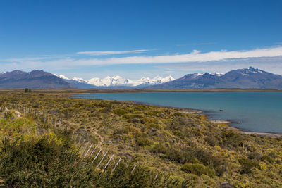 Scenic view of landscape and sea against sky