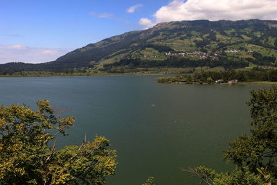 Scenic view of lake and mountains against sky