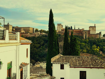 High angle view of buildings in town against sky
