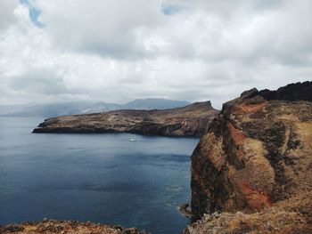 Scenic view of sea and mountains against sky