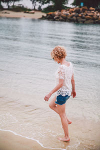 Full length of woman standing on beach