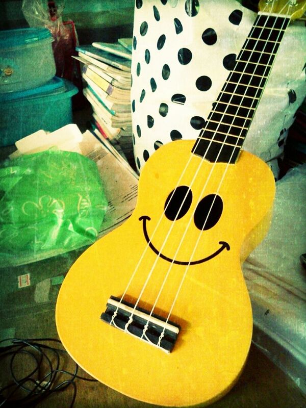 indoors, musical instrument, music, yellow, arts culture and entertainment, guitar, high angle view, close-up, wood - material, sport, musical equipment, green color, communication, no people, table, still life, hobbies, shadow, chair, musical instrument string