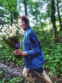 Woman standing in forest