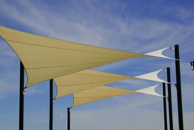 Close-up of yellow flag against blue sky
